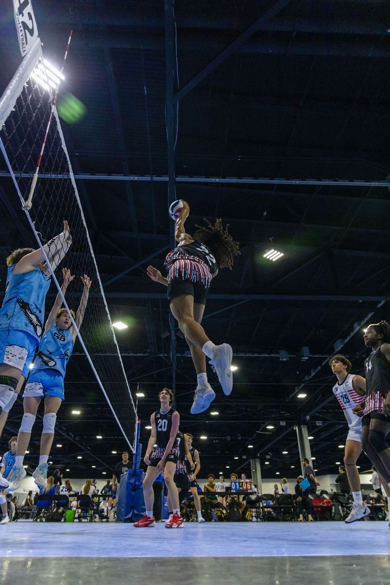 Jaxon Clark hitting the ball mid-air in a match